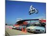 Daredevil Motorcyclist Evil Knievel in Mid Jump over a Row of Cars-Ralph Crane-Mounted Premium Photographic Print