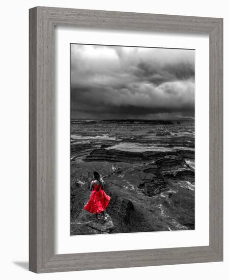 Dark storm clouds over Dead Horse Point State Park with girl in red dress standing near the cliff-David Chang-Framed Photographic Print