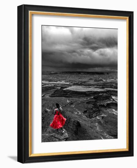 Dark storm clouds over Dead Horse Point State Park with girl in red dress standing near the cliff-David Chang-Framed Photographic Print