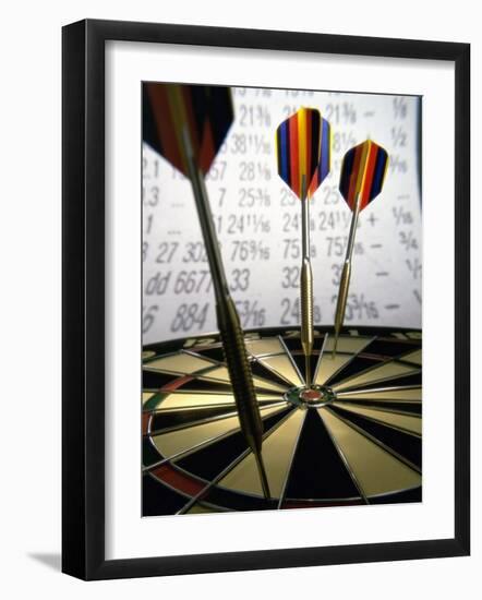 Darts on a Dartboard with Stock Figures in the Background-null-Framed Photographic Print