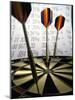 Darts on a Dartboard with Stock Figures in the Background-null-Mounted Photographic Print