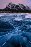 Ice cracks along Abraham Lake in Banff, Canada with purple clouds and scenic mountains-David Chang-Photographic Print