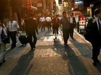 Japanese Commuters Walk Through a Tokyo Street on Their Way to the Train Stations-David Guttenfelder-Photographic Print
