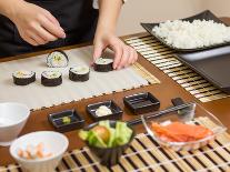 Woman Chef Filling Japanese Sushi Rolls with Rice-David Pereiras-Photographic Print