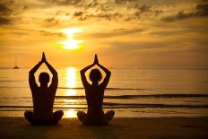 Young Couple Practicing Yoga On The Sea Beach At Sunset-De Visu-Art Print