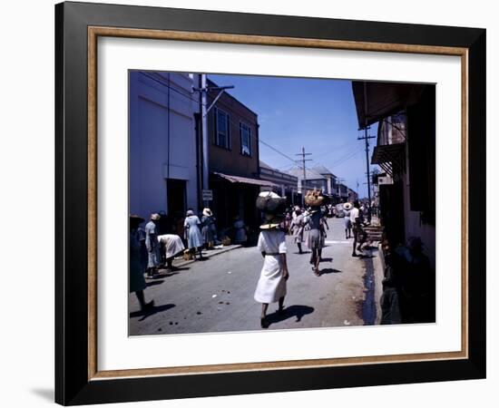 December 1946: Passersby at Market Street in Montego Bay, Jamaica-Eliot Elisofon-Framed Photographic Print