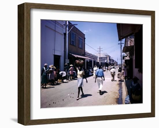 December 1946: Passersby at Market Street in Montego Bay, Jamaica-Eliot Elisofon-Framed Photographic Print