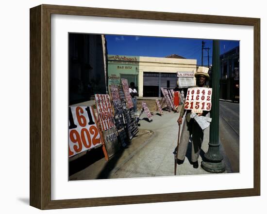 December 1946: War Veteran Sells Lottery Tickets for the Government Lottery in Camaguey, Jamaica-Eliot Elisofon-Framed Photographic Print