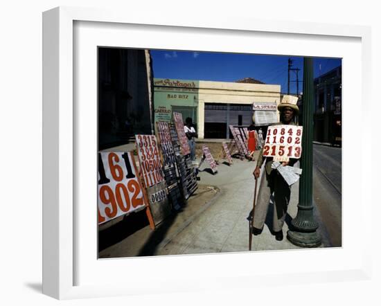 December 1946: War Veteran Sells Lottery Tickets for the Government Lottery in Camaguey, Jamaica-Eliot Elisofon-Framed Photographic Print