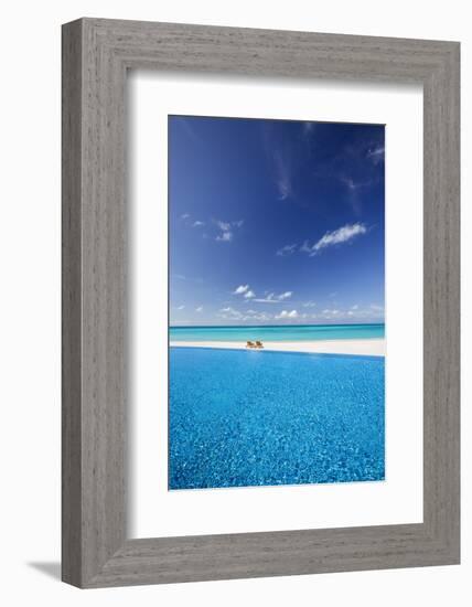 Deck chairs and infinity pool over amazing tropical lagoon, The Maldives, Indian Ocean, Asia-Sakis Papadopoulos-Framed Photographic Print