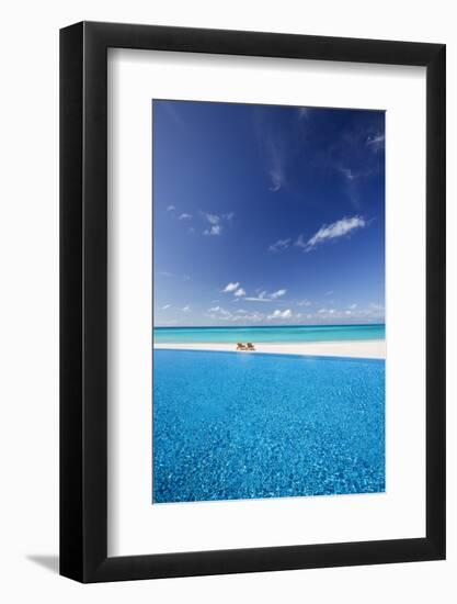 Deck chairs and infinity pool over amazing tropical lagoon, The Maldives, Indian Ocean, Asia-Sakis Papadopoulos-Framed Photographic Print