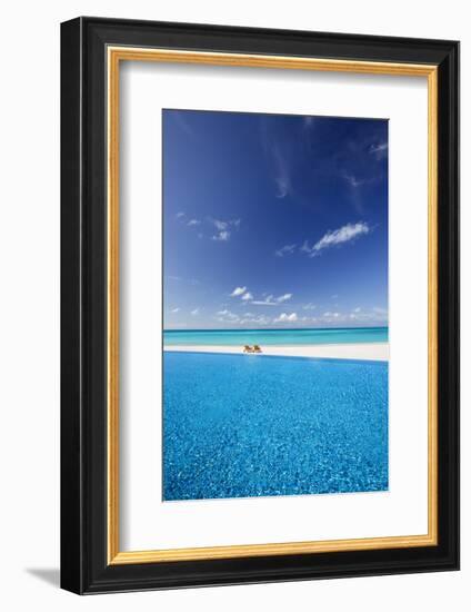 Deck chairs and infinity pool over amazing tropical lagoon, The Maldives, Indian Ocean, Asia-Sakis Papadopoulos-Framed Photographic Print