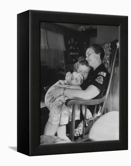 Den Mother Still in Uniform, Sleeping While Holding Her Daughter-null-Framed Premier Image Canvas