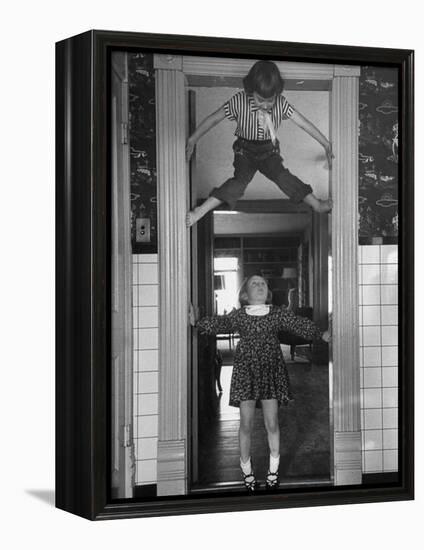 Denise Bruene Climbing Kitchen Door in Bare Feet, Her Hobby, Jan Bruene Says "Don't Fall on Me"-Gordon Parks-Framed Premier Image Canvas