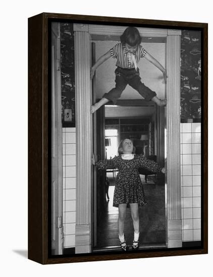 Denise Bruene Climbing Kitchen Door in Bare Feet, Her Hobby, Jan Bruene Says "Don't Fall on Me"-Gordon Parks-Framed Premier Image Canvas