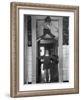 Denise Bruene Climbing Kitchen Door in Bare Feet, Her Hobby, Jan Bruene Says "Don't Fall on Me"-Gordon Parks-Framed Photographic Print
