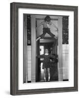 Denise Bruene Climbing Kitchen Door in Bare Feet, Her Hobby, Jan Bruene Says "Don't Fall on Me"-Gordon Parks-Framed Photographic Print