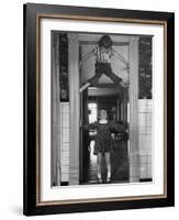 Denise Bruene Climbing Kitchen Door in Bare Feet, Her Hobby, Jan Bruene Says "Don't Fall on Me"-Gordon Parks-Framed Photographic Print