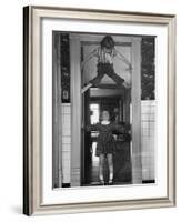 Denise Bruene Climbing Kitchen Door in Bare Feet, Her Hobby, Jan Bruene Says "Don't Fall on Me"-Gordon Parks-Framed Photographic Print