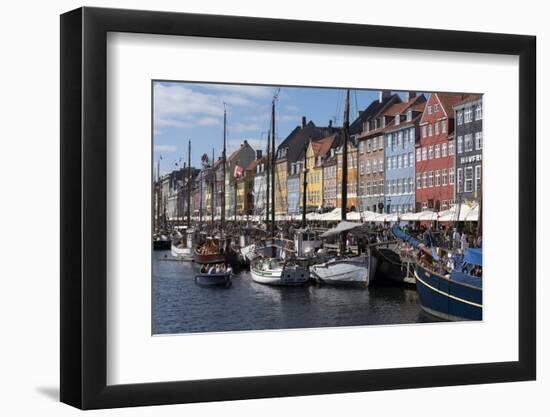 Denmark, Copenhagen, Nyhavn district. Colorful 17th and 18th century buildings, boats and canal-Alan Klehr-Framed Photographic Print