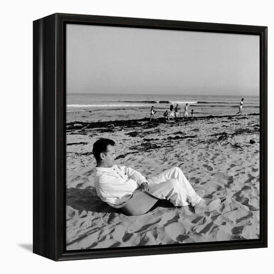 Designer Charles Eames Sitting on a Beach Near His Home-Peter Stackpole-Framed Premier Image Canvas