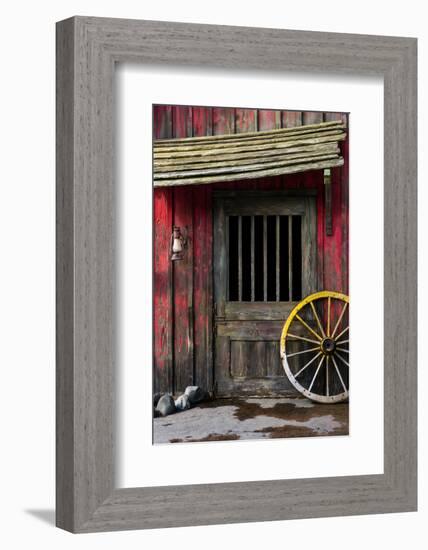 Detail of Old Wagon Wheel next to a Wooden Wild West Typical House-ccaetano-Framed Photographic Print