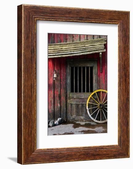 Detail of Old Wagon Wheel next to a Wooden Wild West Typical House-ccaetano-Framed Photographic Print