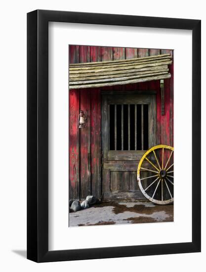 Detail of Old Wagon Wheel next to a Wooden Wild West Typical House-ccaetano-Framed Photographic Print