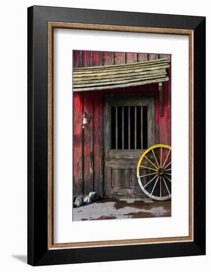 Detail of Old Wagon Wheel next to a Wooden Wild West Typical House-ccaetano-Framed Photographic Print