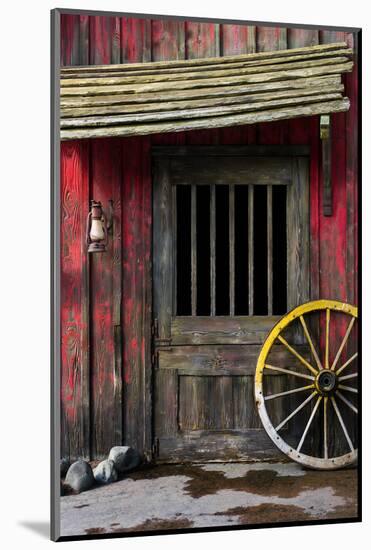 Detail of Old Wagon Wheel next to a Wooden Wild West Typical House-ccaetano-Mounted Photographic Print