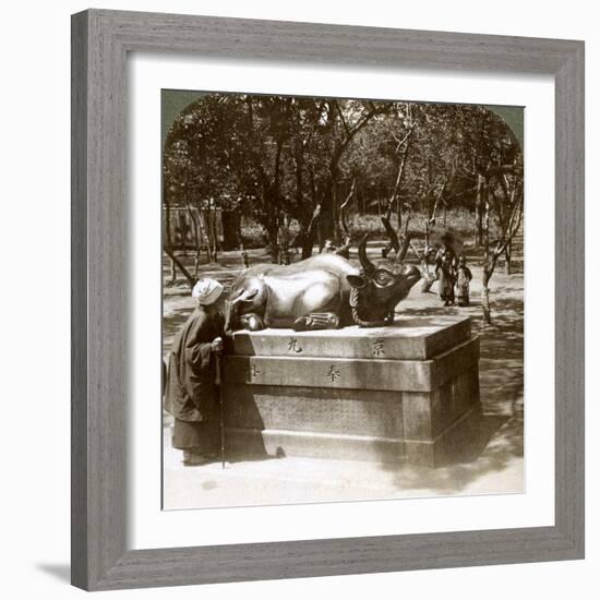 Devout Woman Stroking a Bronze Bull to Cure Rheumatism, Kitano Tenjin Temple, Kyoto, Japan, 1904-Underwood & Underwood-Framed Photographic Print