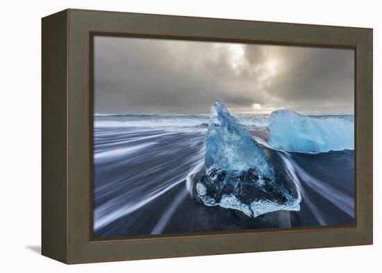 Diamond ice chards from calving icebergs on black sand beach, Jokulsarlon, south Iceland-Chuck Haney-Framed Premier Image Canvas