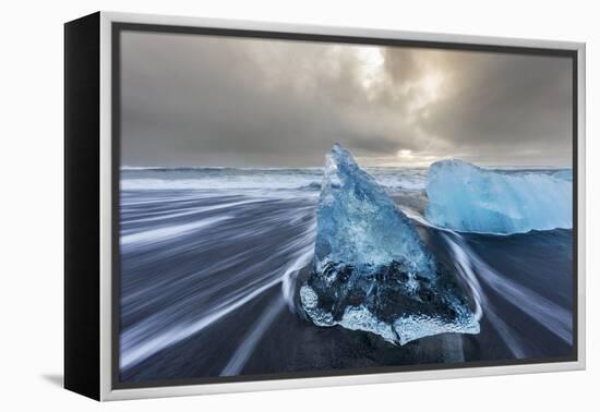 Diamond ice chards from calving icebergs on black sand beach, Jokulsarlon, south Iceland-Chuck Haney-Framed Premier Image Canvas