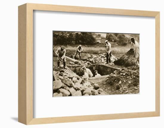 Digging mass graves behind the German lines, World War I, c1914-c1918-Unknown-Framed Photographic Print