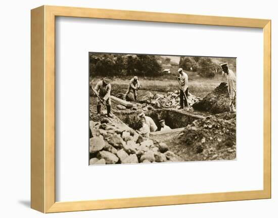 Digging mass graves behind the German lines, World War I, c1914-c1918-Unknown-Framed Photographic Print