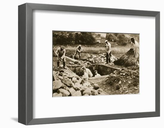 Digging mass graves behind the German lines, World War I, c1914-c1918-Unknown-Framed Photographic Print