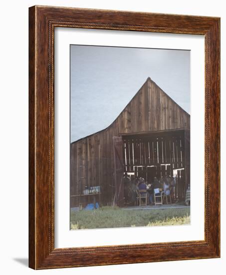 Diners Enjoying A Locally Sourced Dinner Inside An Old Barn In Sierraville Valley, California-Shea Evans-Framed Photographic Print