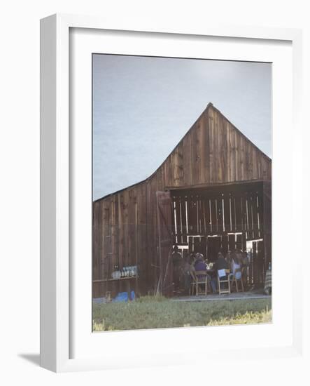 Diners Enjoying A Locally Sourced Dinner Inside An Old Barn In Sierraville Valley, California-Shea Evans-Framed Photographic Print