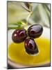 Dipping Olive Sprig with Black Olives in Olive Oil-null-Mounted Photographic Print