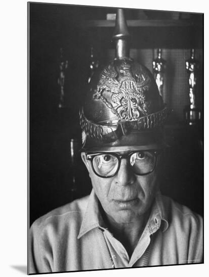 Director Billy Wilder in His Hollywood Office Wearing German Helmet-Gjon Mili-Mounted Premium Photographic Print