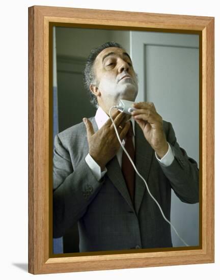 Director Federico Fellini with Powder on His Face as He Shaves with an Electric Shaver-Carlo Bavagnoli-Framed Premier Image Canvas