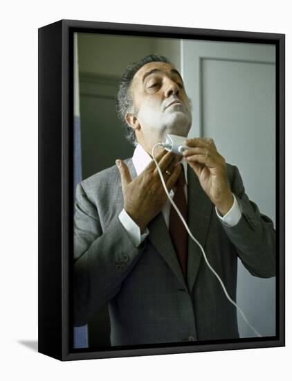 Director Federico Fellini with Powder on His Face as He Shaves with an Electric Shaver-Carlo Bavagnoli-Framed Premier Image Canvas