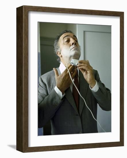Director Federico Fellini with Powder on His Face as He Shaves with an Electric Shaver-Carlo Bavagnoli-Framed Photographic Print