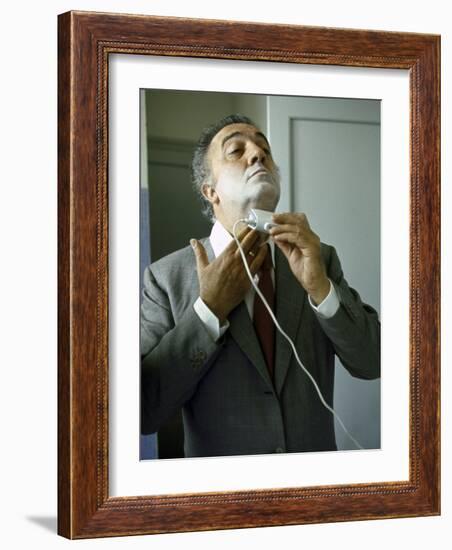 Director Federico Fellini with Powder on His Face as He Shaves with an Electric Shaver-Carlo Bavagnoli-Framed Photographic Print