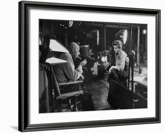 Director Howard Hawks Conferring with Actress Angie Dickinson on Set for "Rio Bravo"-Allan Grant-Framed Premium Photographic Print