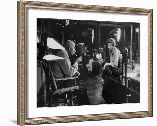 Director Howard Hawks Conferring with Actress Angie Dickinson on Set for "Rio Bravo"-Allan Grant-Framed Premium Photographic Print