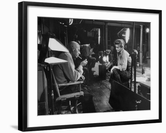 Director Howard Hawks Conferring with Actress Angie Dickinson on Set for "Rio Bravo"-Allan Grant-Framed Premium Photographic Print