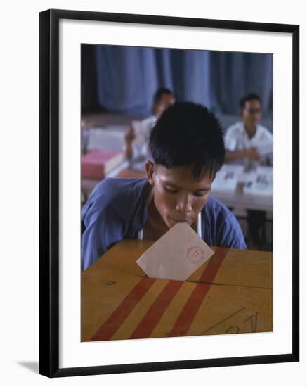 Disabled South Vietnamese Soldier Casting a Vote into a Ballot Box at Cong Hoa Army Hospital-Larry Burrows-Framed Premium Photographic Print