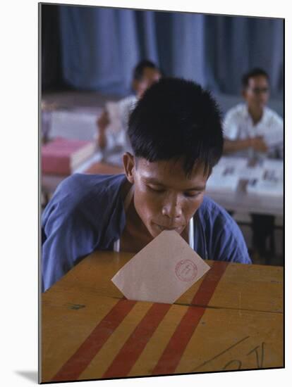 Disabled South Vietnamese Soldier Casting a Vote into a Ballot Box at Cong Hoa Army Hospital-Larry Burrows-Mounted Premium Photographic Print