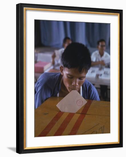 Disabled South Vietnamese Soldier Casting a Vote into a Ballot Box at Cong Hoa Army Hospital-Larry Burrows-Framed Premium Photographic Print